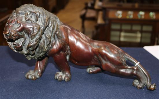 A Japanese brown patinated bronze figure of a roaring lion, Meiji period, length 34cm